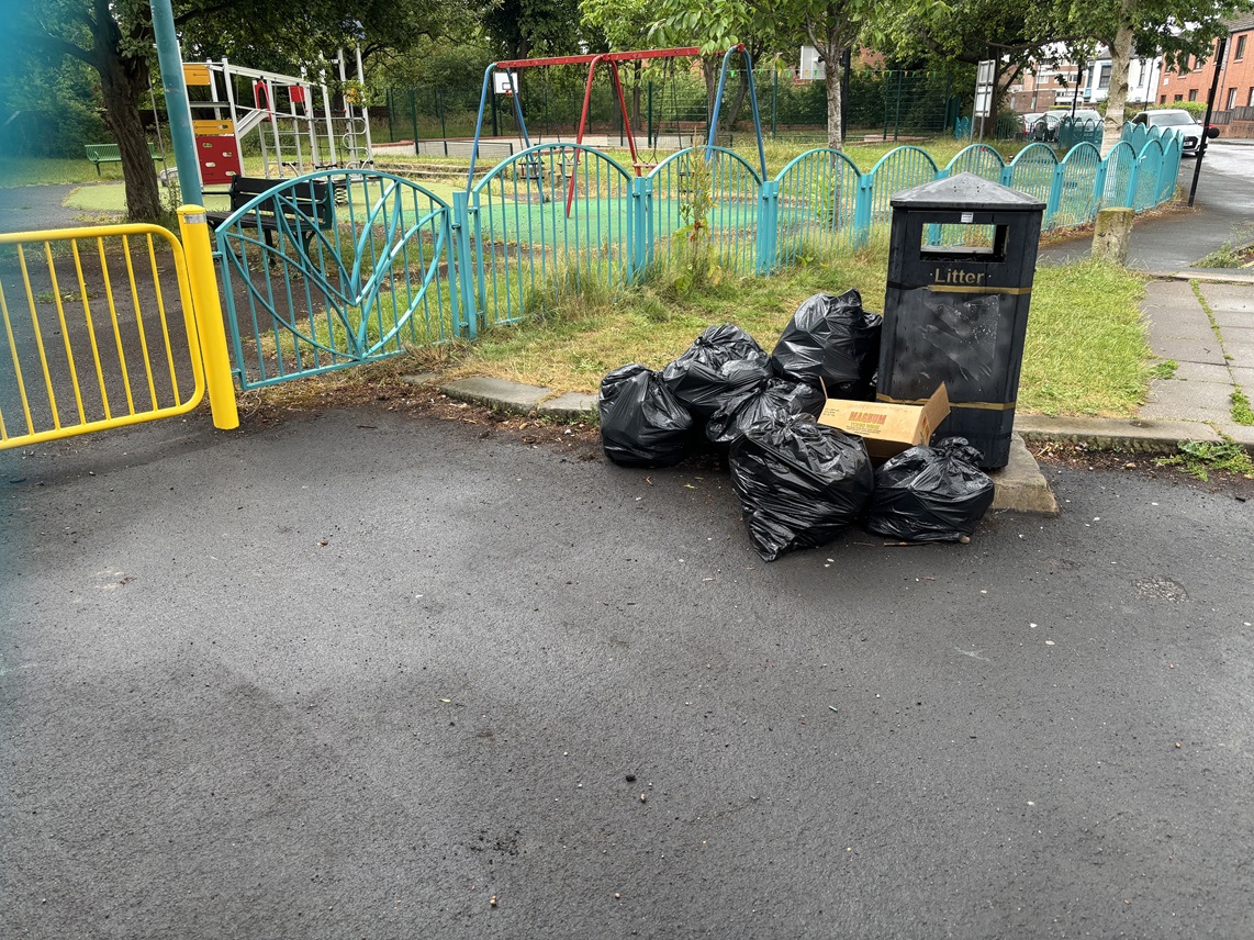 Flytipping rubbish next to bin near park