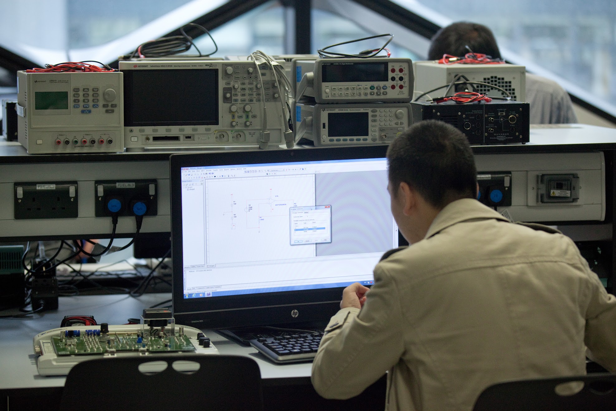 A student surrounded by laboratory equipment