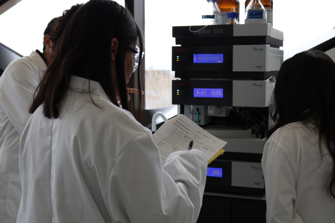 Students study the read outs on a computer screen