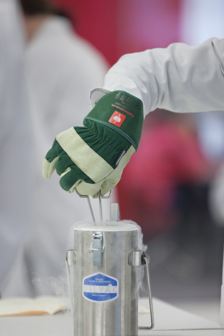 A technician immerses a sample in liquid nitrogen