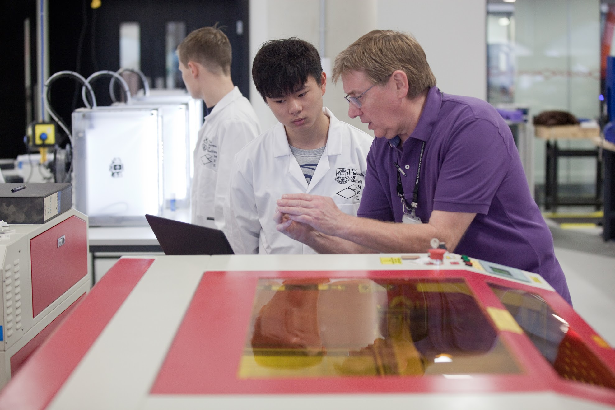 A technician explains a computer read out to a student